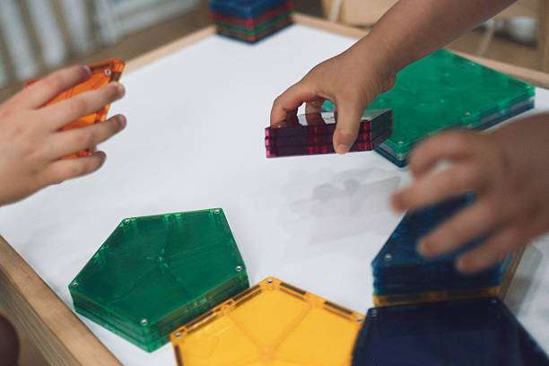 Kids building and creating with magnetic tiles