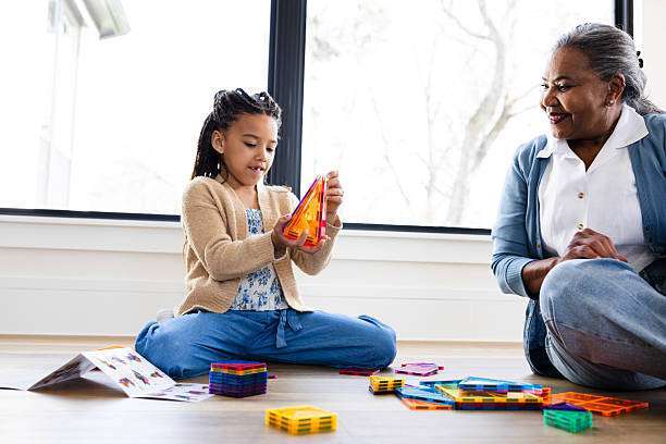A girl builds with magnetic tiles