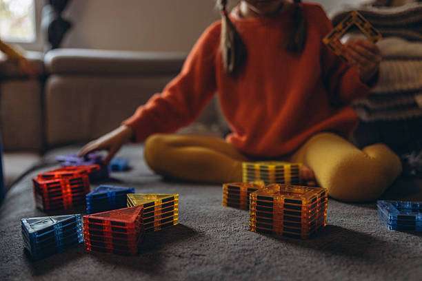 a child plays with a magnetic tiles construction set