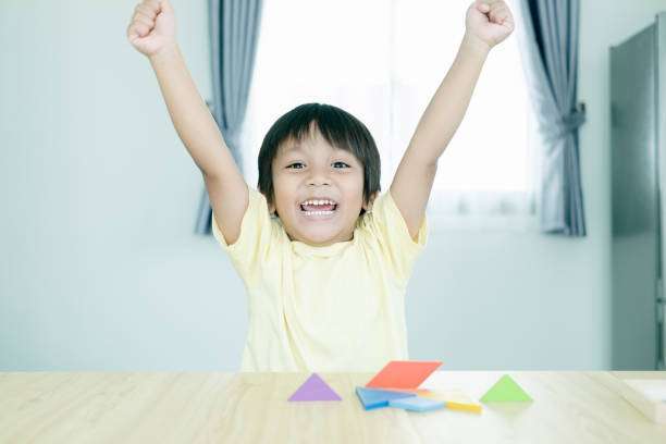 Portrait of happy Asian boy kid magnetic tiles