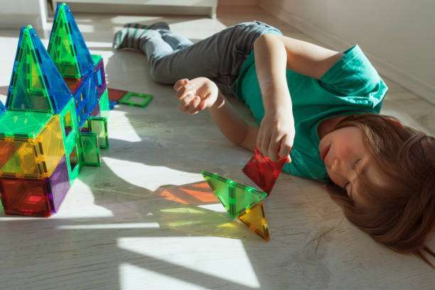 a child plays with a magnetic tiles construction set