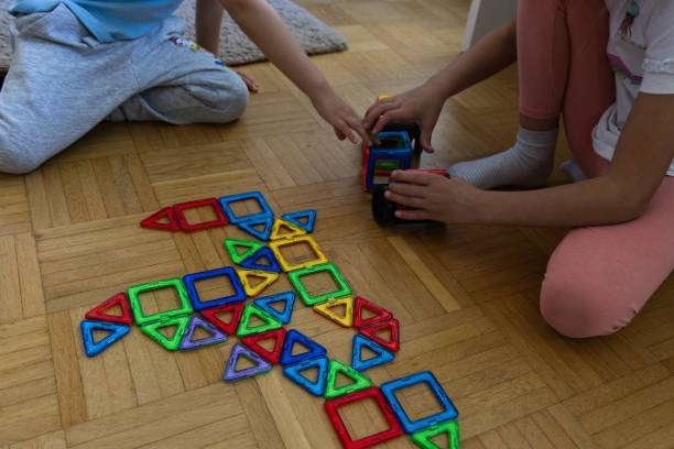 a child plays with a magnetic tiles construction set