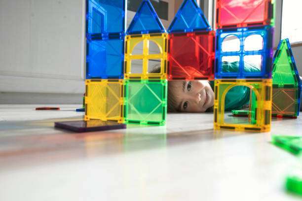 A child plays with a magnetic tiles