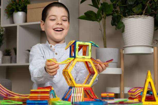 A child plays with a magnetic tiles