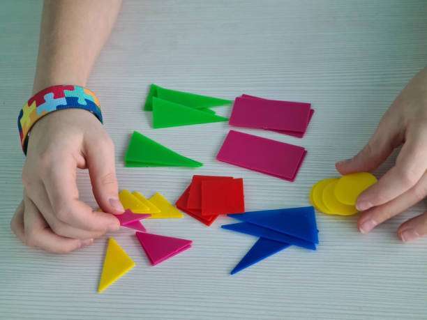 Little girl playing at home with interactive magnet toys. Lleisure games.magnetic tiles