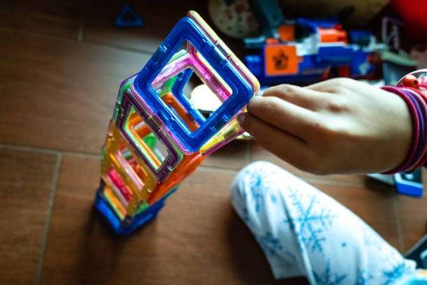 View of toddler playing with magnet letters text on magnetic tiles
