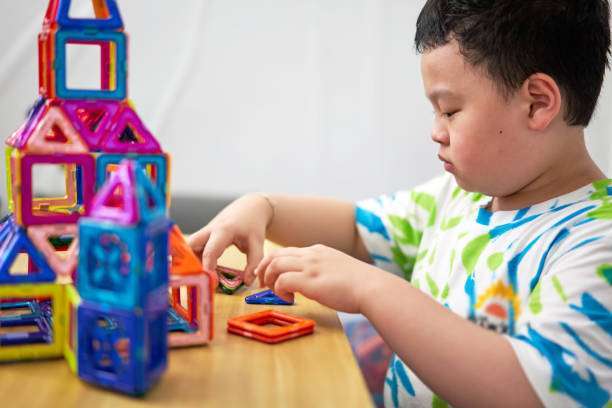 boy building a toy house be creative magnetic tiles