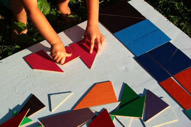 The child plays with a colorful magnetic tiles constructor. Close-up. Ball.